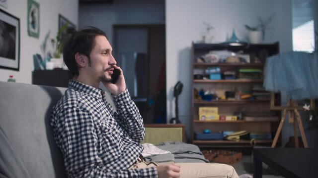 the guy is sitting and talking indignantly on the phone
