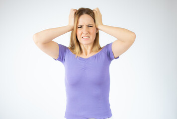 Portrait of a young angry woman over white background.