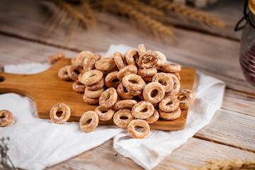Pile of sweet russian bagel bread rings with sugar on the wooden background