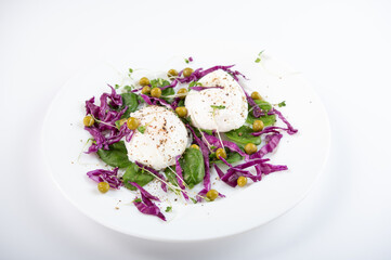 Boiled eggs on a plate. Eggs with salad on a white plate.