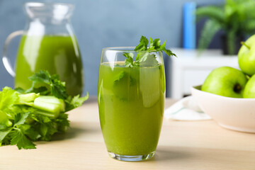 Glass of fresh celery juice on white table, closeup