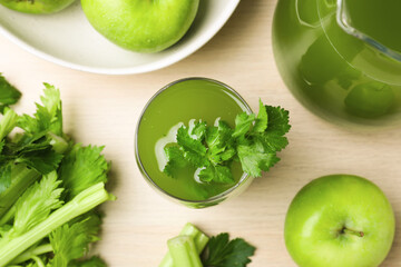 Glass of celery juice with fresh ingredients on white table, flat lay