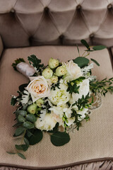 Beautiful wedding bouquet of roses close-up on the sofa.