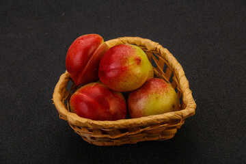 Sweet small nectarines in the basket