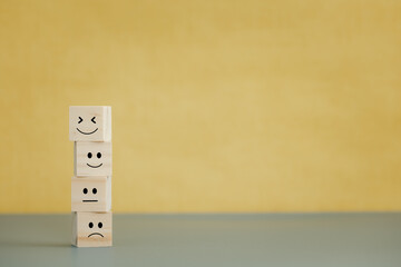 emotion faces on wooden cubes for satisfaction survey