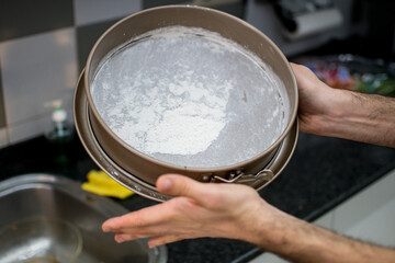 Mold being floured for a carrot cake