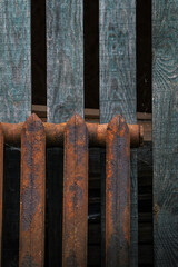 Rusty radiator as decoration. New style decorations. Rusty radiator on green wood background.