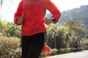 Fototapeta premium Fitness woman runner running on winter park trail