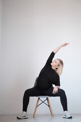 Staying fit and healthy. Beautiful young woman in sports clothing doing yoga while relaxing at home