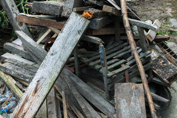Forgotten sled among old timber. Stack of timber.