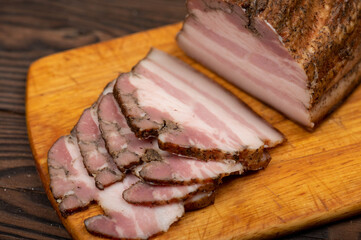 Smoked brisket sliced on a wooden chopping board.