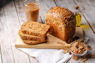 Side view on cereal bread loafs on the wooden decorated background