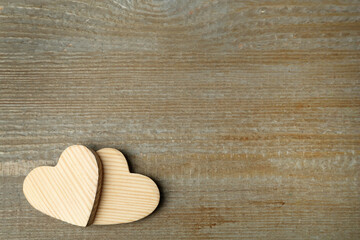 Decorative hearts and space for text on wooden table, flat lay. Valentine's Day