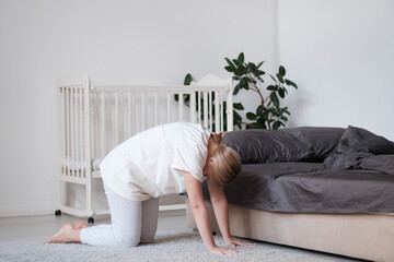 Staying fit and healthy. Beautiful young woman in sports clothing doing yoga while relaxing at home