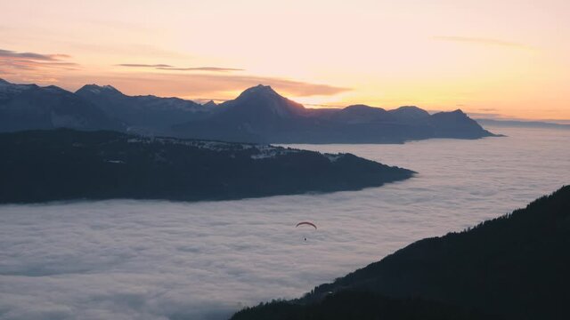 Paragliding Over Beautiful Sea Of Clouds At Dusk In France. - wide shot