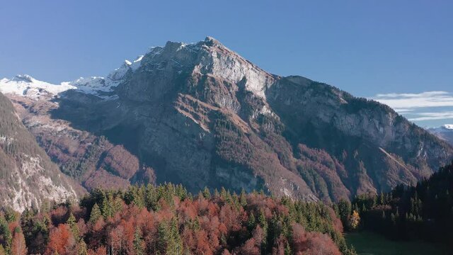Beautiful rock mountain of La Rosière in France by the forest in autumn -aerial