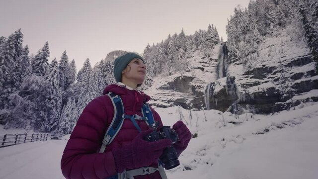 Female Photographer Amazed By Wonderful Snowy Landscape In Sixt-Fer-a-Cheval, France In Winter. medium shot, slow motion