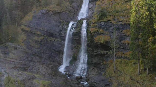 Beautiful flat rock waterfall of Cascade du Rouget, France in autumn -aerial ascend