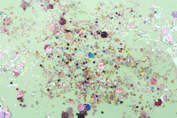 Shiny colorful glitter on light background, flat lay