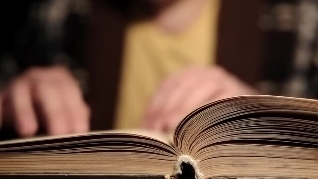 Man is reading old antique book at home