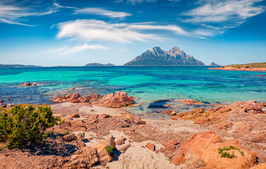 Beautiful marine scenery. Sunny spring view of Tavolara island from Spiaggia del dottore beach. Stunning morning scene of Sardinia island, Italy, Europe. Attractive Mediterranean seascape.