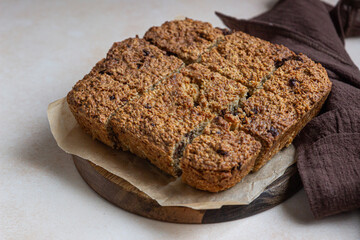 Oatmeal squares with chocolate, light concrete background. Diet bars. Healthy bakery for breakfast or dessert.