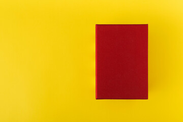 Red box on yellow background top view. Red rectangle on yellow background. Copy space. Mock up