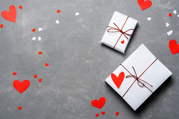 Valentines day gifts on gray with red hearts