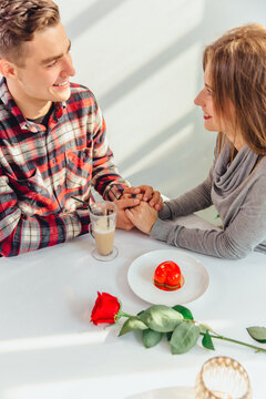 Lovely cropped shot of affectionale boy and girl, holding hands, ready to their first kiss.