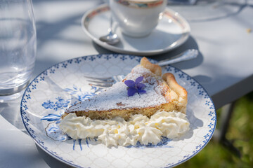 Fresh self made easter pie with flower decoration and coffee outdoor.
