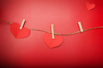 Red paper origami hearts on craft rope