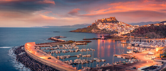 Сharm of the ancient cities of Europe. Panoramic evening cityscape of Castelsardo port. Stunning...