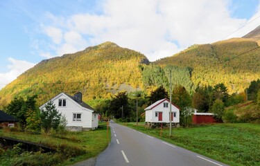 Fototapeta na wymiar Wooden cabins along the road of the rural village Urke, Norway