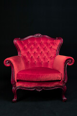 red Isolated Bergère armchair on black background