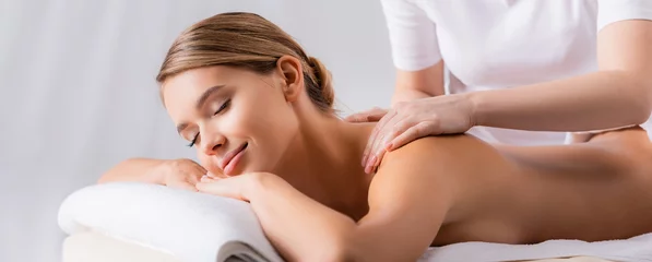 Fotobehang masseur massaging pleased client lying on massage table, banner © LIGHTFIELD STUDIOS