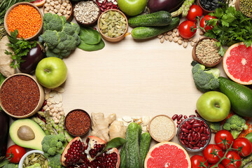 Frame of fresh vegetables, fruits and seeds on light table, flat lay. Space for text