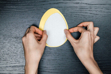 How to make a Paper Egg Greeting card for Easter greetings. Doing paper crafts. oncept of DIY. Step-by-step photo instructions. Step 8. Glue the smaller white egg onto the larger colored egg