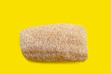 Sponge gourd for bath on yellow background.