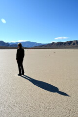 single person standing on the Racetrack Playa in the Death Valley National Park - one man exploration the sailing stones, a phenomenon in the desert, a mysterious travel destination in California