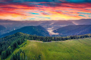 Naklejka na ściany i meble Aerial landscape photography. Splendid summer view from flying drone of mountain valley. Stunning sunrise in Carpathian mountains, Ukraine, Europe. Beauty of nature concept background.