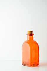 Orange glass bottle on white background.	