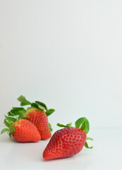 Fresh strawberries close-up, white background and copy space.