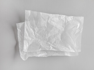 crumpled sheets of white baking paper