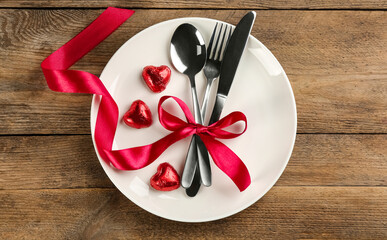Beautiful table setting for Valentine's Day dinner on wooden background, top view