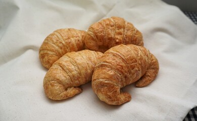 Fresh croissants on a white sheet