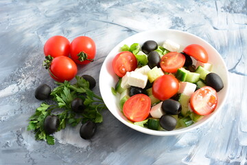 greek salad with tomatoes feta olives and cucumber on the concrete background
