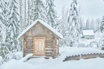 frame house in the forest in winter
