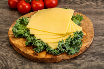 Sliced Gauda cheese over board