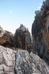 Calcareous rocks and boulders on the beachfront at sundown. Marina di  Camerota, Salerno, Italy.