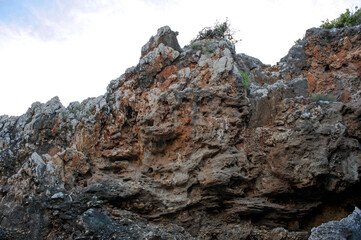 The typical limestone rock of the mountains in the Cilento area that makes stunning cliffs and many...
